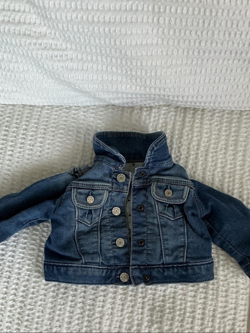 Baby B'gosh blue denim jacket features functional front pockets  a button-down